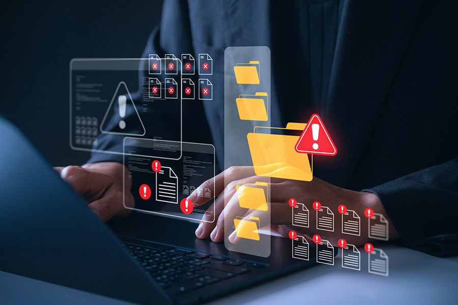 working on laptop with file security alerts