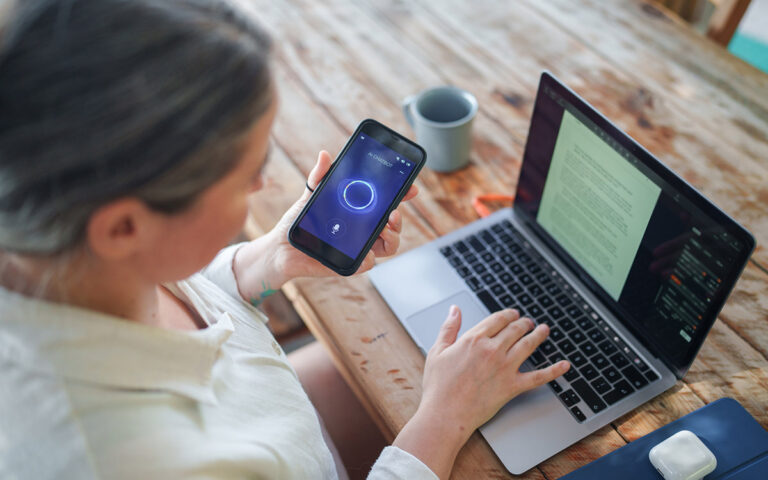 woman at work with her lapto and phone